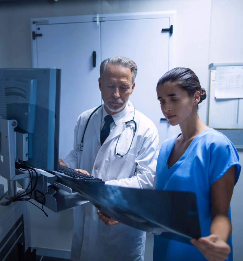 Doctor and nurse reviewing an X-ray for long-term care facility operations Doctor and nurse reviewing an X-ray for long-term care facility operations